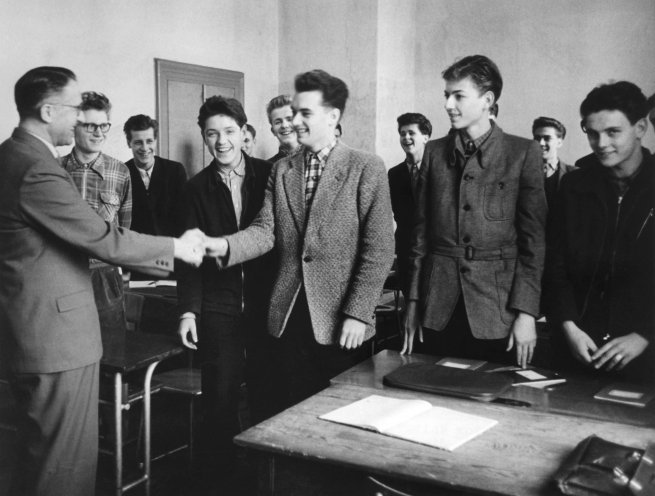 Oberstudienrat Walter Sauer (links) gratuliert im Januar 1957 im Aufbaugymnasium in Bensheim den beiden neuen Klassensprechern Bernd-Jürgen Weimann (links) und Dieter Portner zu ihrer Wahl. Quelle: picture-alliance/dpa/Heinz-Jürgen Göttert