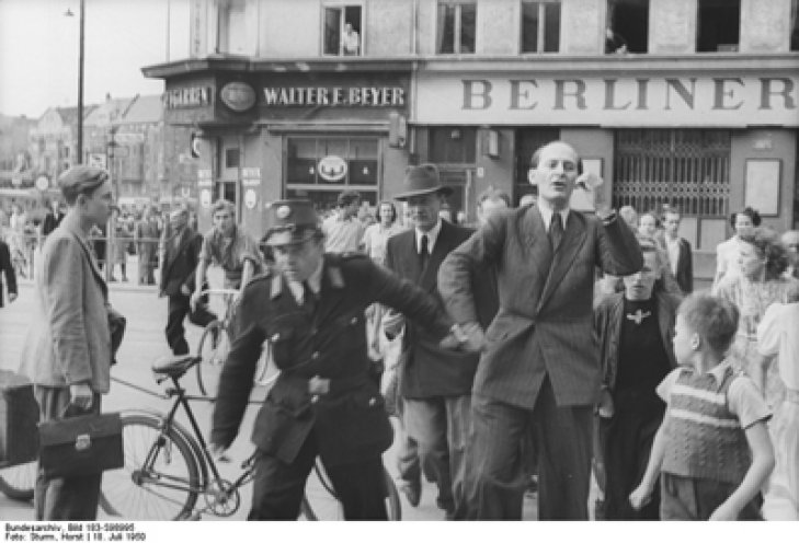 Robert Havemann wird von einem Westberliner Polizisten während der Kampagne für die Unterzeichnung des Stockholmer Appells gegen Atomwaffen festgenommen, 8. Juli 1950.