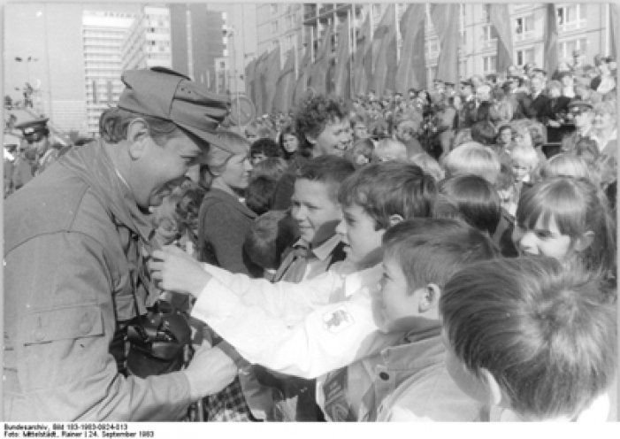 Im Gleichschritt Marsch: Zu Ihrem 30jährigen Bestehen halten am 24. September 1983 10.000 Mitglieder der Kampfgruppen eine Parade ab. Dabei überreichten Pioniere ihre Halstücher an die Kämpfer. 
Quelle: Bundesarchiv/183-1983-0924-013/Rainer Mittelstädt